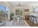 Bright dining room with a glass table, modern chairs, and a sliding door with a view of the outside at 6850 Xavier Cir # 5, Westminster, CO 80030
