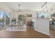 Open-concept dining room with a modern table, chairs, and access to the balcony at 6850 Xavier Cir # 5, Westminster, CO 80030