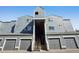 Exterior shot of building featuring garage doors and staircase to units at 6850 Xavier Cir # 5, Westminster, CO 80030