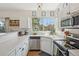 Bright kitchen with stainless steel appliances, a breakfast bar, and a large window at 6850 Xavier Cir # 5, Westminster, CO 80030