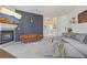 Open living space with modern furniture, fireplace, and access to hallway at 6850 Xavier Cir # 5, Westminster, CO 80030