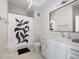 Modern bathroom with white vanity, shower, and patterned shower curtain at 1208 Quitman St # 303, Denver, CO 80204