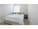 Bright bedroom with a queen-size bed and bedside table at 1208 Quitman St # 303, Denver, CO 80204
