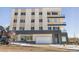 Three-story building exterior with parking and snow on the ground at 1208 Quitman St # 303, Denver, CO 80204