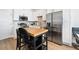 Modern kitchen with stainless steel appliances and butcher block island at 1208 Quitman St # 303, Denver, CO 80204