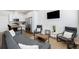 Living room features grey couches, wood coffee table, and kitchen with island at 1208 Quitman St # 303, Denver, CO 80204
