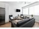 Bright living room with grey sofas and chairs, coffee table, and ceiling fan at 1208 Quitman St # 303, Denver, CO 80204