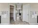 Bright bathroom with a walk in closet on the left and a bedroom through the doorway at the end of the hall at 12110 Bay Oaks Ct, Parker, CO 80138