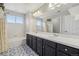 Bathroom with a double sink vanity and patterned tile floors at 12110 Bay Oaks Ct, Parker, CO 80138