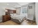 Bedroom with light wood floors, a dresser, and a large window at 12110 Bay Oaks Ct, Parker, CO 80138