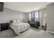 Spacious bedroom with carpet, two windows, and a surfboard leaning against the wall at 12110 Bay Oaks Ct, Parker, CO 80138