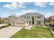 Beautiful two-story home with a three car garage and manicured front yard at 12110 Bay Oaks Ct, Parker, CO 80138