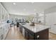 Bright and open kitchen with island, stainless steel appliances, and hardwood floors at 12110 Bay Oaks Ct, Parker, CO 80138