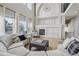 Open living room features a fireplace, large windows, and comfortable seating at 12110 Bay Oaks Ct, Parker, CO 80138