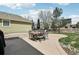 Outdoor patio features dining table and basketball hoop for entertainment at 12110 Bay Oaks Ct, Parker, CO 80138