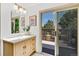 Stylish bathroom with modern vanity and a scenic view of the outdoor balcony through a sliding glass door at 10016 Teton Ct, Lone Tree, CO 80124