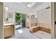 Beautiful bathroom featuring modern shower, skylight, and natural light with a walkout to the deck at 10016 Teton Ct, Lone Tree, CO 80124