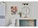Charming bathroom with marble countertops, modern fixtures, a stylish mirror, and a colorful floral art piece at 10016 Teton Ct, Lone Tree, CO 80124