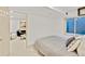 Comfortable bedroom with neutral walls, a sliding door to a living space, and a plush bed with stylish pillows at 10016 Teton Ct, Lone Tree, CO 80124