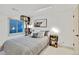 Cozy bedroom featuring neutral colored walls and carpet, decorative shelving, and a comfortable looking bed at 10016 Teton Ct, Lone Tree, CO 80124