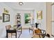 Bright home office with a large window, sleek black desk, and tasteful decor, creating an ideal workspace at 10016 Teton Ct, Lone Tree, CO 80124