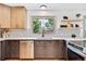 Updated kitchen features stainless appliances, modern backsplash, and ample cabinet space at 10016 Teton Ct, Lone Tree, CO 80124