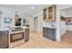 Modern kitchen island and view to the open-concept living area and fireplace at 10016 Teton Ct, Lone Tree, CO 80124
