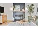 Cozy living room with a painted brick fireplace, stylish decor, and lots of natural light at 10016 Teton Ct, Lone Tree, CO 80124