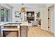 Open-concept living area with a stylish kitchen island, cozy fireplace, and comfortable seating at 10016 Teton Ct, Lone Tree, CO 80124