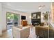 Bright living room with a brick fireplace, slider to backyard, and modern furnishings at 10016 Teton Ct, Lone Tree, CO 80124