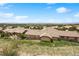 Expansive aerial view of a single-Gathering home, revealing its desert landscaping, beautiful facade, and community at 4364 Chateau Ridge Ln, Castle Rock, CO 80108