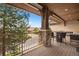 Balcony features stone supports, wood decking, seating, and neighborhood views at 4364 Chateau Ridge Ln, Castle Rock, CO 80108