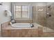 Relax in this bathroom with a separate shower and tub and views of the outdoors at 4364 Chateau Ridge Ln, Castle Rock, CO 80108