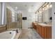 This bathroom features dual sinks, a tub, and a glass enclosed shower at 4364 Chateau Ridge Ln, Castle Rock, CO 80108