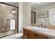 Nicely tiled bathroom featuring a glass shower and wooden vanity with sink at 4364 Chateau Ridge Ln, Castle Rock, CO 80108