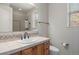 Bright bathroom features a large mirror, a window, and tile floors at 4364 Chateau Ridge Ln, Castle Rock, CO 80108
