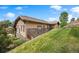 Beautiful, single story home with tan stucco and stone facade surrounded by landscaped yard and stone retaining wall at 4364 Chateau Ridge Ln, Castle Rock, CO 80108