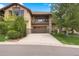 Charming two-story house featuring an attached garage, stone accents, balcony, and a well-manicured lawn at 4364 Chateau Ridge Ln, Castle Rock, CO 80108