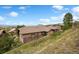 Stunning view of single-Gathering home exterior featuring stucco and stone facade, landscaping, and incredible mountain views at 4364 Chateau Ridge Ln, Castle Rock, CO 80108