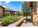 View of a home's exterior featuring well-kept landscaping, stone details, and a cozy balcony at 4364 Chateau Ridge Ln, Castle Rock, CO 80108