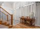 Hallway featuring hardwood floors, a desk, and a staircase with white curtains at 4364 Chateau Ridge Ln, Castle Rock, CO 80108