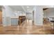 Bright hallway with hardwood floors, white trim and railing, and natural light from a large window at 4364 Chateau Ridge Ln, Castle Rock, CO 80108