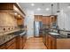 Kitchen featuring wood cabinets, stainless appliances, tile backsplash, granite countertops and wood flooring at 4364 Chateau Ridge Ln, Castle Rock, CO 80108