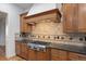 This Kitchen has stainless steel appliances, granite countertops, tile backsplash, and wood cabinets at 4364 Chateau Ridge Ln, Castle Rock, CO 80108