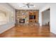 Living room features a stone fireplace, built-in tv, and lots of natural light from large windows at 4364 Chateau Ridge Ln, Castle Rock, CO 80108