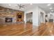 Spacious living room featuring a stone fireplace, built-in tv, wood flooring and open floorplan at 4364 Chateau Ridge Ln, Castle Rock, CO 80108