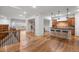 Open concept living space featuring hardwood floors, modern lighting, and a kitchen with breakfast bar at 4364 Chateau Ridge Ln, Castle Rock, CO 80108