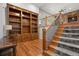 Study with a large wood bookcase, hardwood floors, and stairs to a second level at 4364 Chateau Ridge Ln, Castle Rock, CO 80108