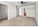 Bedroom with carpeted floors, ceiling fan and open bathroom and closet at 17359 Waterhouse Cir # C, Parker, CO 80134