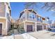Two-story townhome features attached garages, stylish siding, and snow-covered landscaping at 17359 Waterhouse Cir # C, Parker, CO 80134
